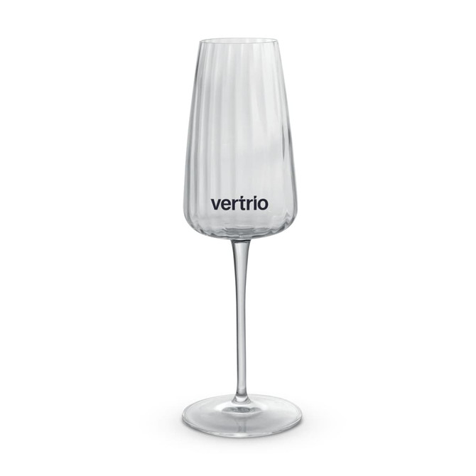 A clear glass flute featuring vertical ridges and a logo on the front, set on a slender stem.