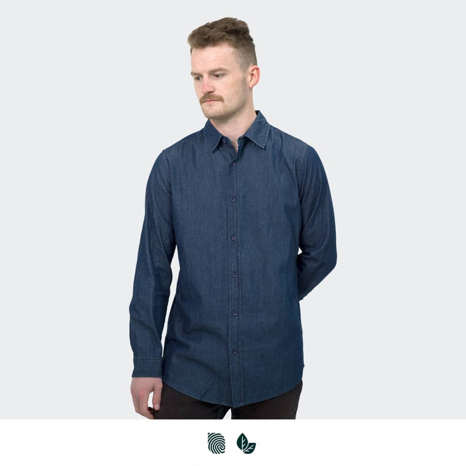 A man wearing a dark blue button-up denim shirt, featuring long sleeves and a fitted design.
