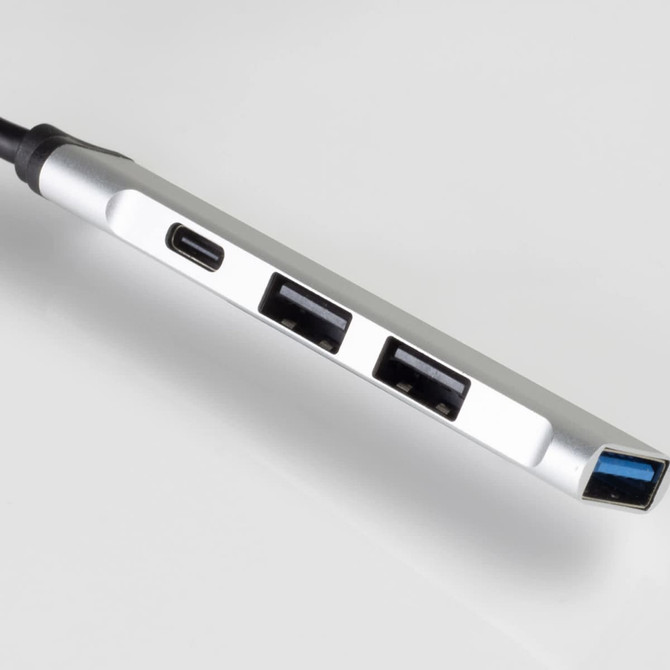 A silver USB hub with multiple ports, including USB-A and USB-C, on a white background.