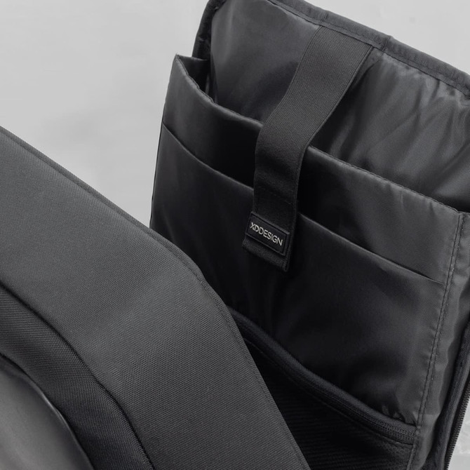 A black anti-theft backpack briefcase with multiple internal compartments and a logo tag.