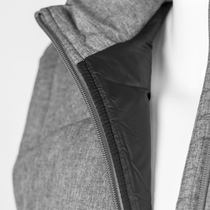 A grey women's puffer vest featuring a black interior and a zippered closure. The vest has a subtle logo.