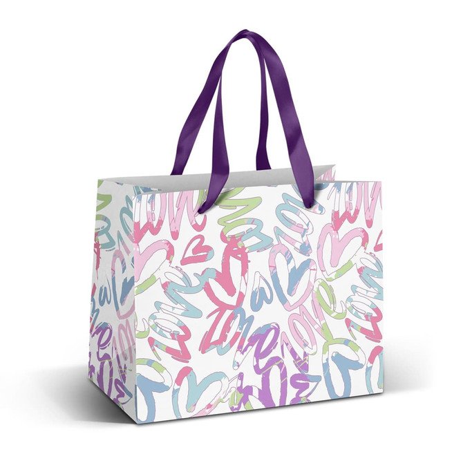 A medium paper bag with a multi-coloured heart and swirl design, featuring purple ribbon handles.