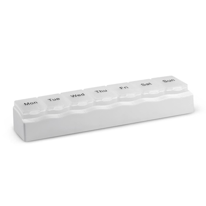 A white medication organiser with compartments labelled for each day of the week.