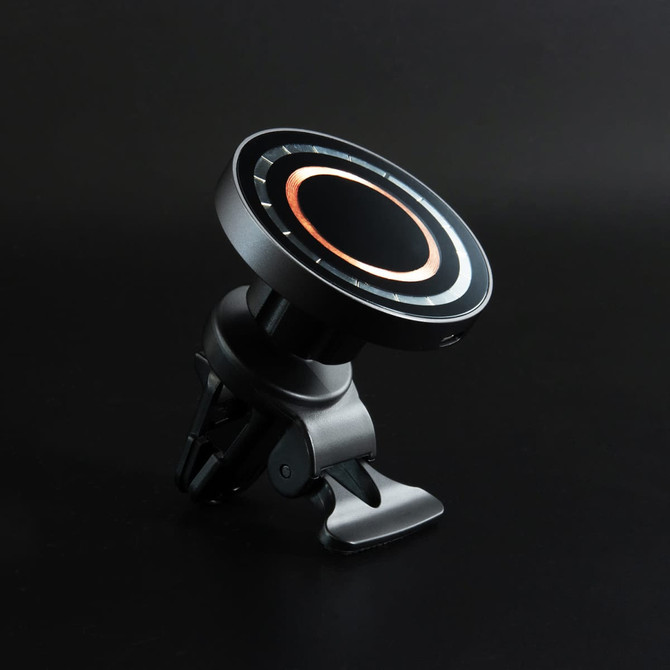 A black wireless car charger with a circular design and a clip mount. It features a ring of bronze accents.