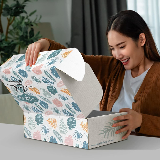 A rectangular die cut box with a locking lid, featuring a floral pattern in greens, blues, and peach tones.