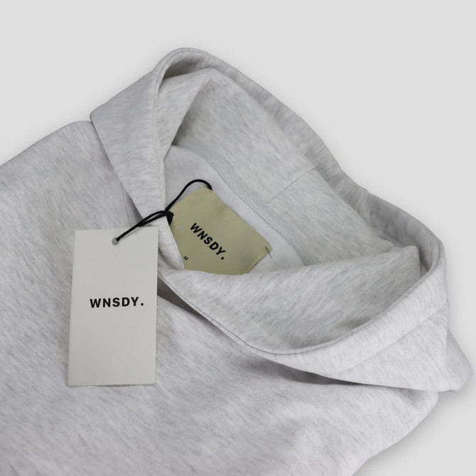 A grey hoodie with a hood and tags, featuring a logo on the tags.