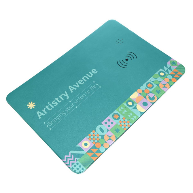 A turquoise wireless charger and mouse pad with a colorful geometric design along one edge and a logo.