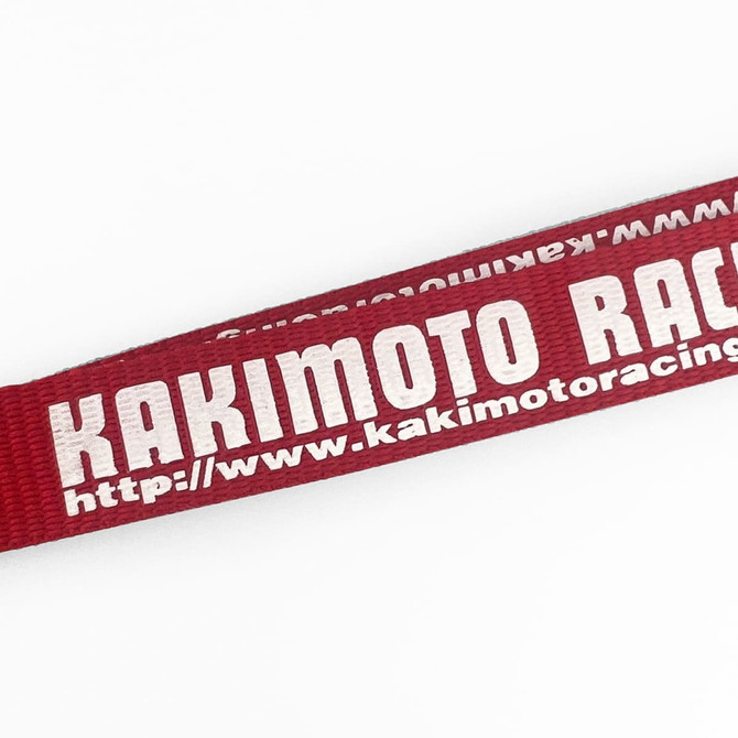A red polyester lanyard featuring text and a logo, measuring 10mm in width.