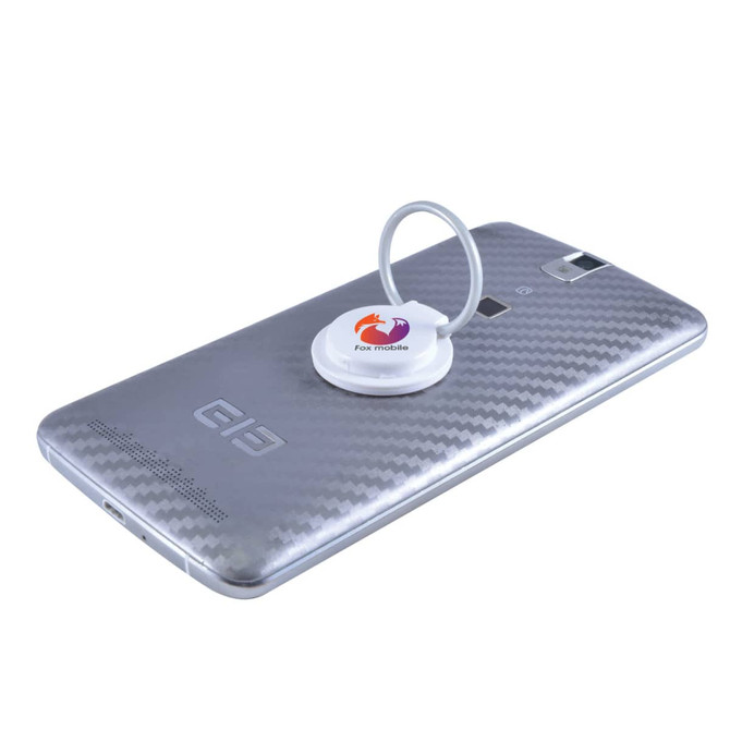 A silver phone with a white circular grip and stand attached to the back, featuring a logo.