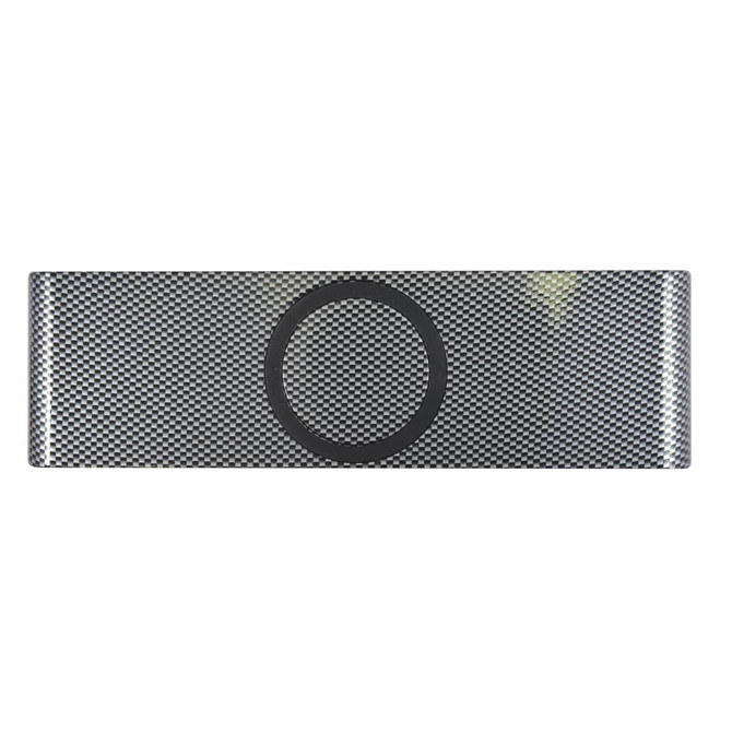 A sleek grey speaker with a textured surface, featuring a circular area for inductive charging.