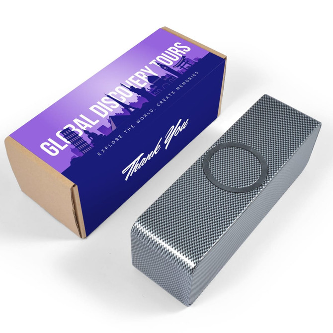 A silver speaker with a metallic finish is displayed beside a colourful box featuring a logo and text.