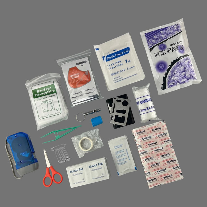 A blue first aid case containing various medical supplies: bandages, alcohol pads, gauze pads, scissors, and an ice pack.