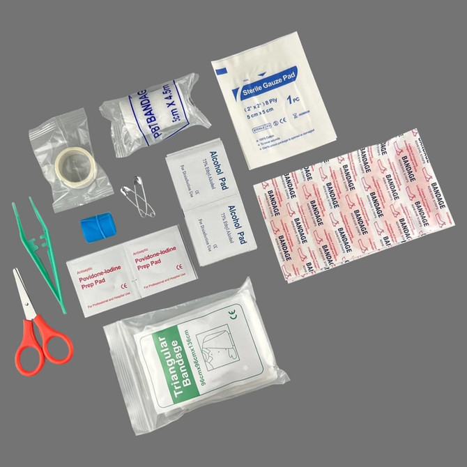 A red and white first aid pouch containing bandages, adhesive pads, scissors, tweezers, and safety pins.
