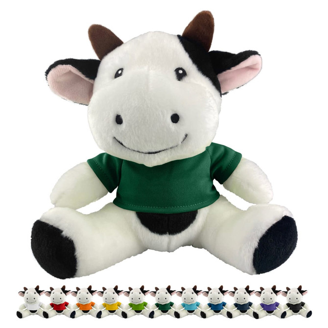 A plush cow toy in black and white with a green shirt, featuring a friendly smile and small horns.