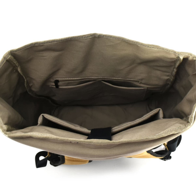 An open beige laptop backpack with compartments and pockets inside. It features a logo on the exterior.