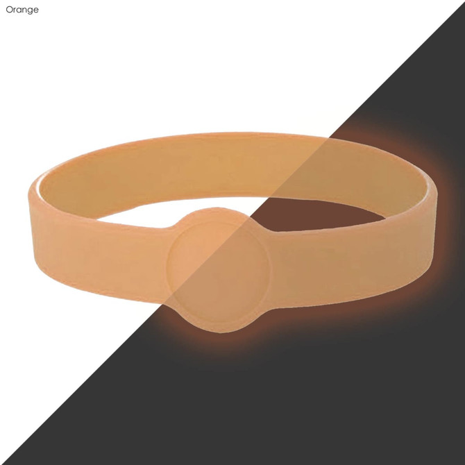 An orange silicone wristband with a flat surface, featuring a circular area, suitable for custom designs.