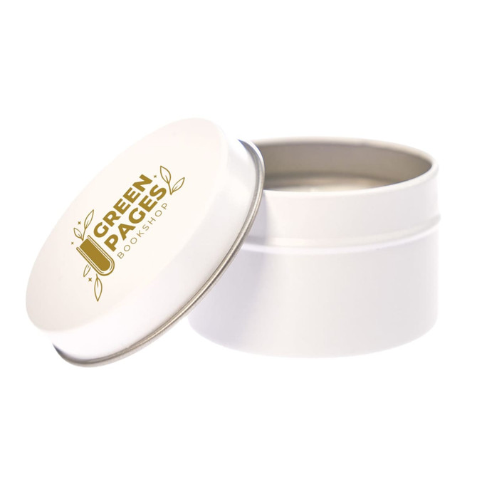 A petite candle in a white tin with a silver lid, featuring a logo that reads "Green Pages Bookshop."