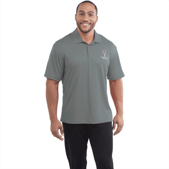 A man wearing a grey Moreno short sleeve polo shirt featuring a logo on the left side.