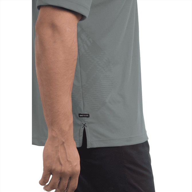 A short sleeve polo shirt in a muted green colour with a logo and a side slit detail.
