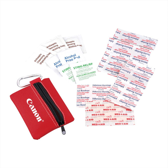 A red zippered pouch containing various first aid supplies, including adhesive bandages, alcohol prep pads, and sting relief wipes.