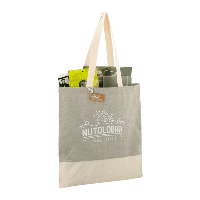A beige and cream tote bag with a logo, featuring various items inside.