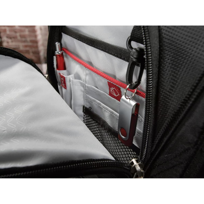 A black backpack interior featuring compartments with red accents and a USB flash drive attached.