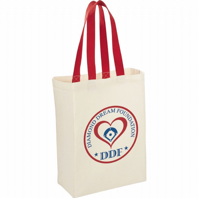Natural cotton grocery tote in cream with red handles and a round logo featuring a heart and text.