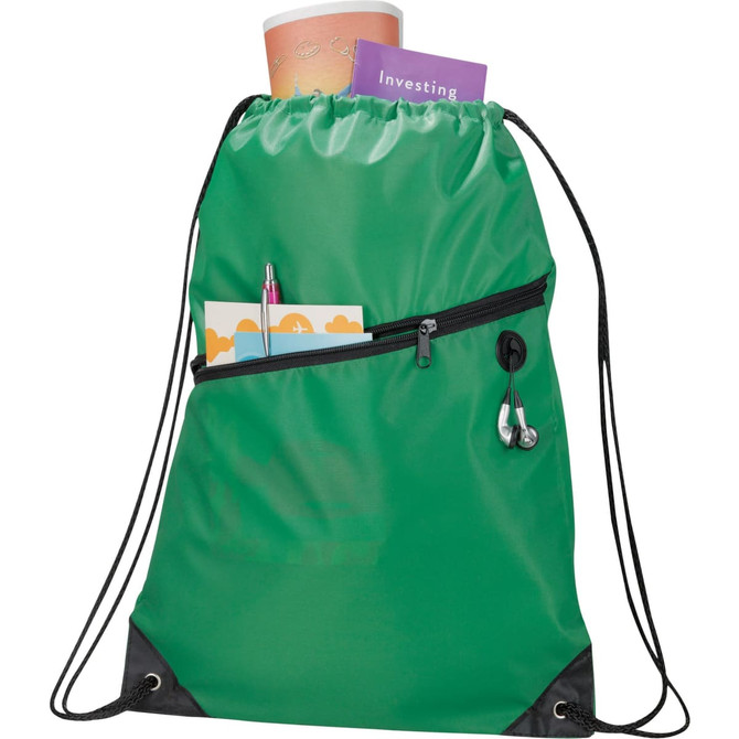 A green drawstring sportspack with a zip pocket, holding a drink bottle, a notebook, and stationery items.