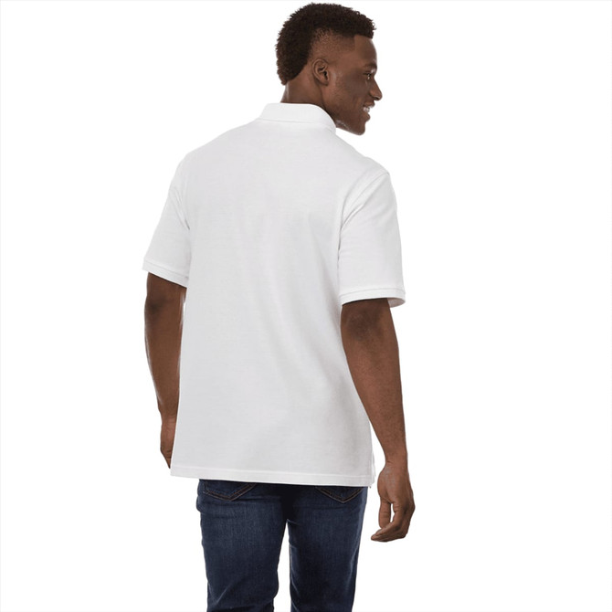 A man wearing a white short sleeve polo shirt, viewed from the back, with denim jeans. The shirt features a logo.