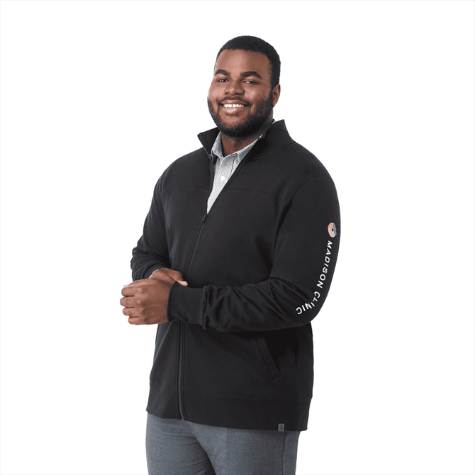 A man is wearing a black full zip fleece jacket with a logo on the sleeve. The jacket features a high collar.