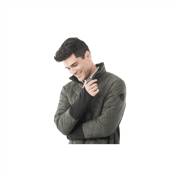 A man in a green insulated jacket with a high collar, featuring a branding logo on the sleeve.