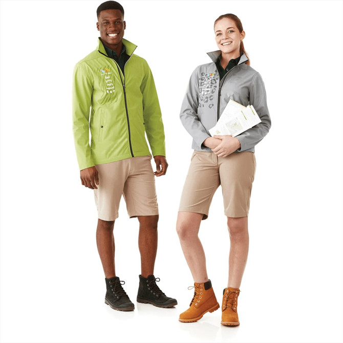 Two models wearing softshell jackets, one in green and the other in grey, paired with shorts and boots.