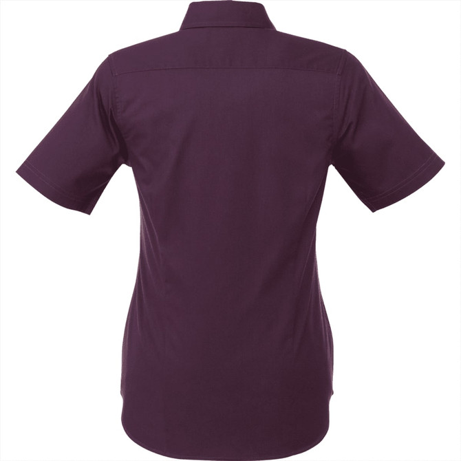 A women's short sleeve button-up shirt in a deep purple colour, featuring a back yoke and collar, with a logo.