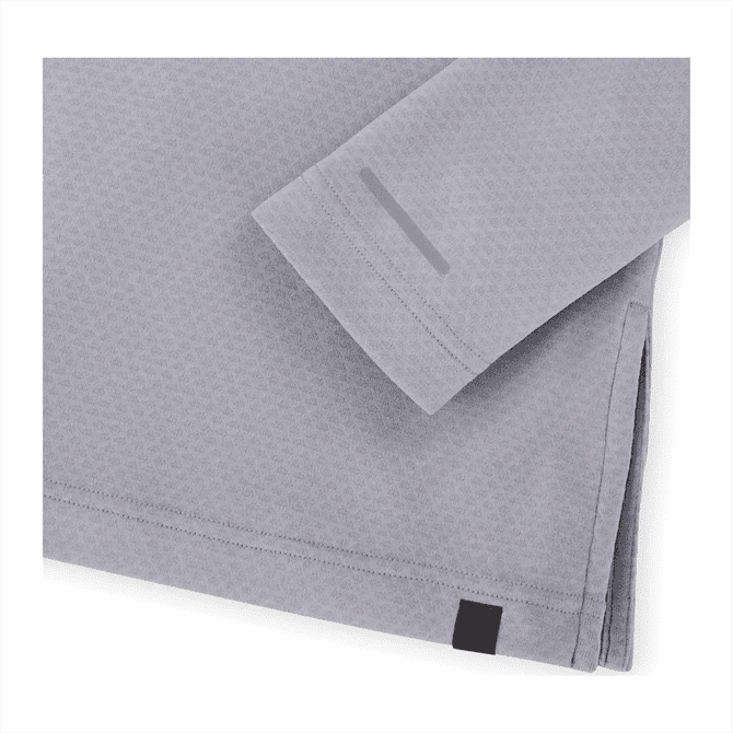 A light grey eco-friendly quarter zip jacket for women, featuring minimalist design and a logo.