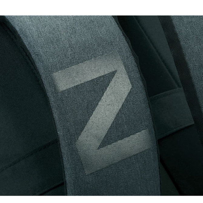 A close-up of the padded strap of a dark green laptop backpack featuring a simple logo.