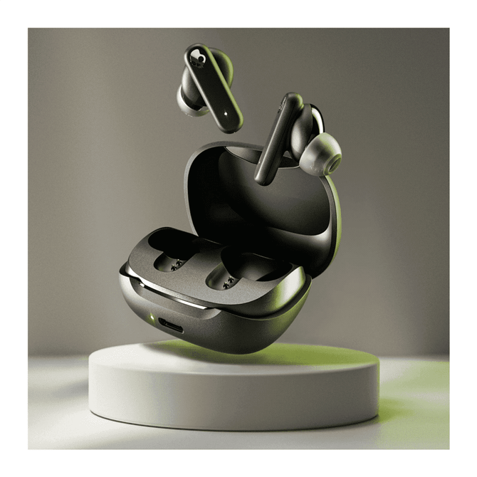 A pair of black earbuds and their charging case on a display stand, with a subtle grey background.