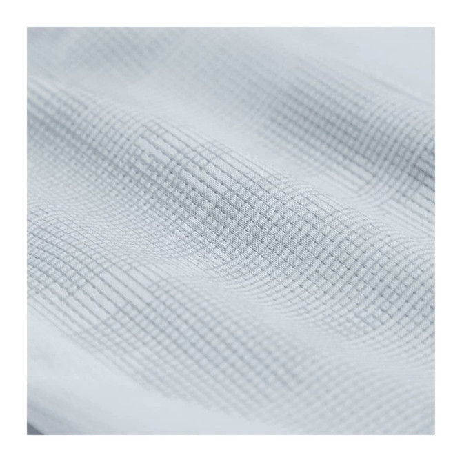 A textured close-up of fabric in a light grey hue, featuring a subtle grid pattern.