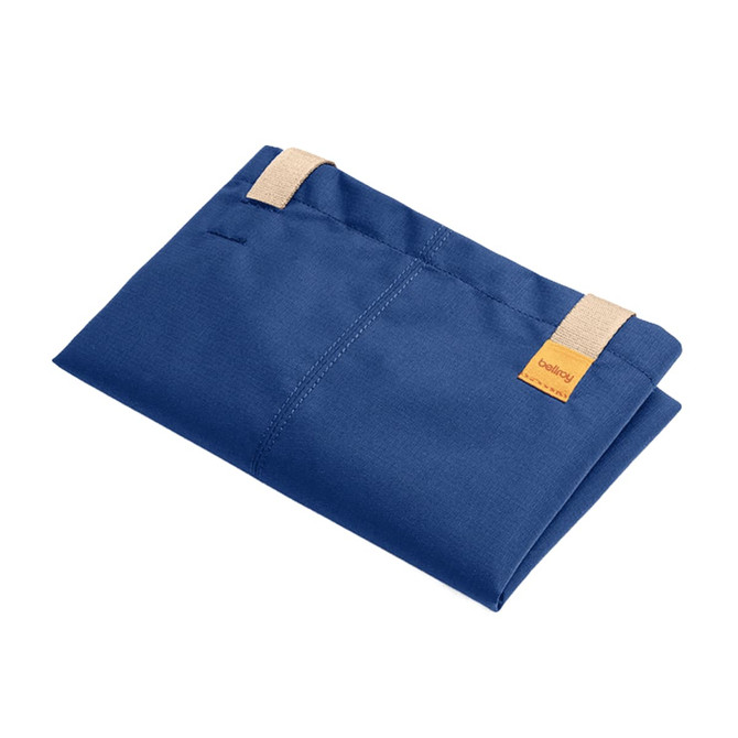 A folded navy tote bag with cream straps and a small logo tag.