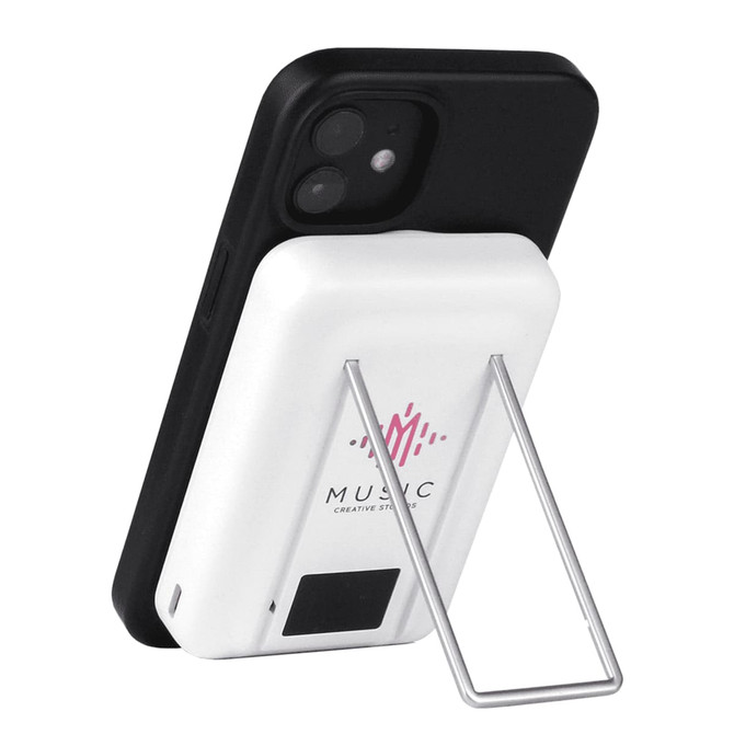 A white magnetic power bank with a phone stand, featuring a silver stand and a black phone attached.