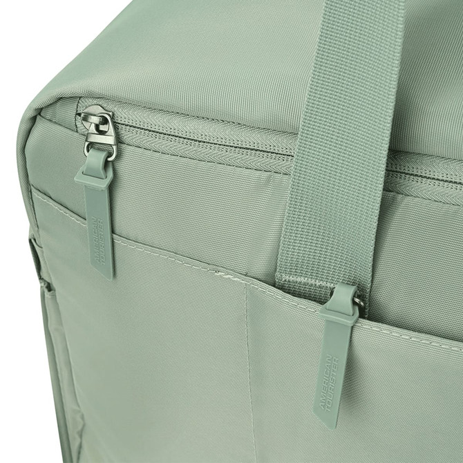 A green duffle bag features a zipper and straps, with pockets on the side and a logo.