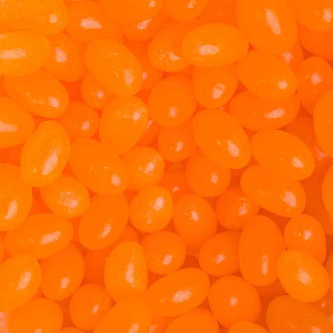 A close-up of bright orange jelly beans in various shapes and sizes, glossy and eye-catching in appearance.