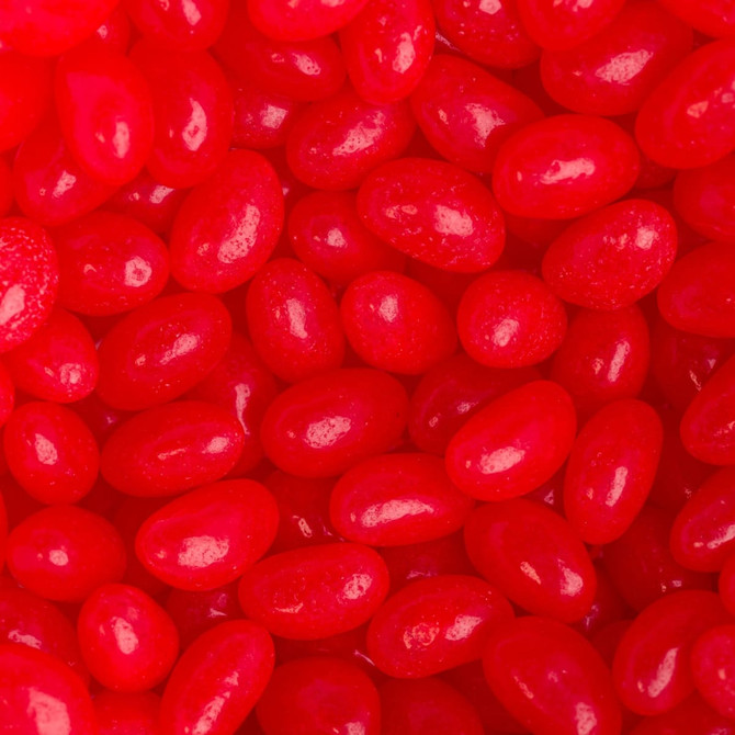 Red jelly beans scattered closely together with a glossy finish, featuring a variety of shapes and sizes.