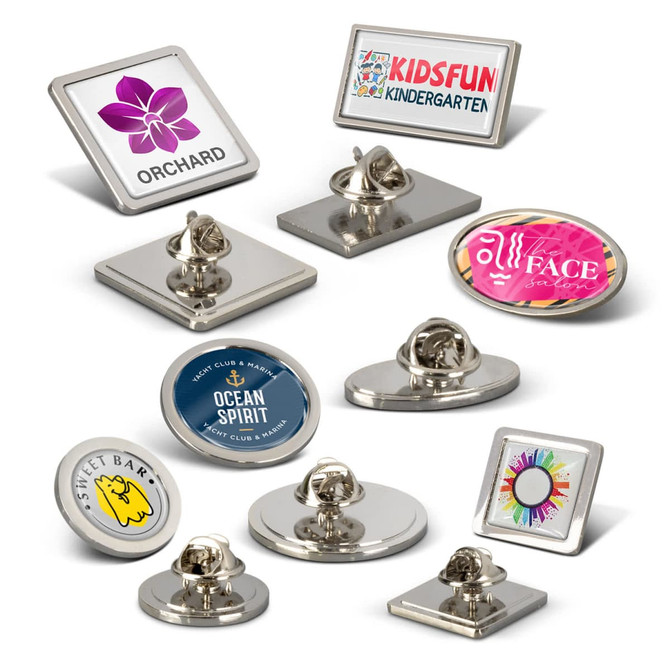 A collection of round and square lapel pins in various colours, featuring different designs and logos.