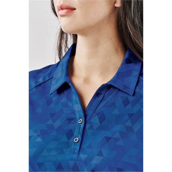 A close-up of a blue women's polo shirt featuring a geometric pattern and a classic collar with buttons.