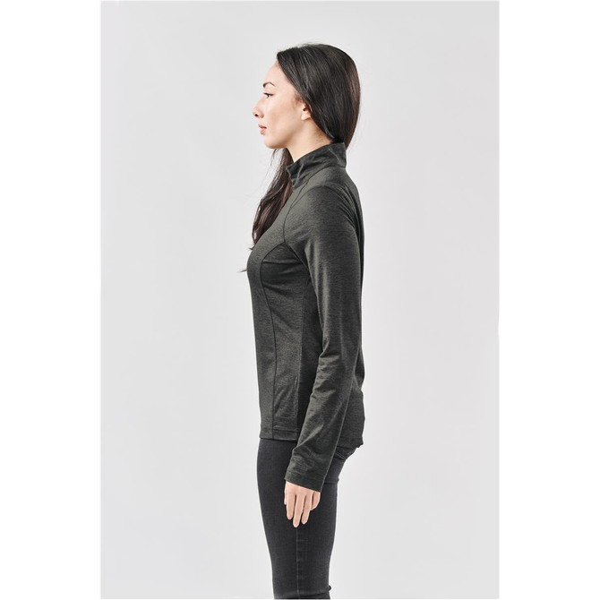 A side view of a woman wearing a dark grey women's Milano 1/4 zip pullover, featuring a fitted design.