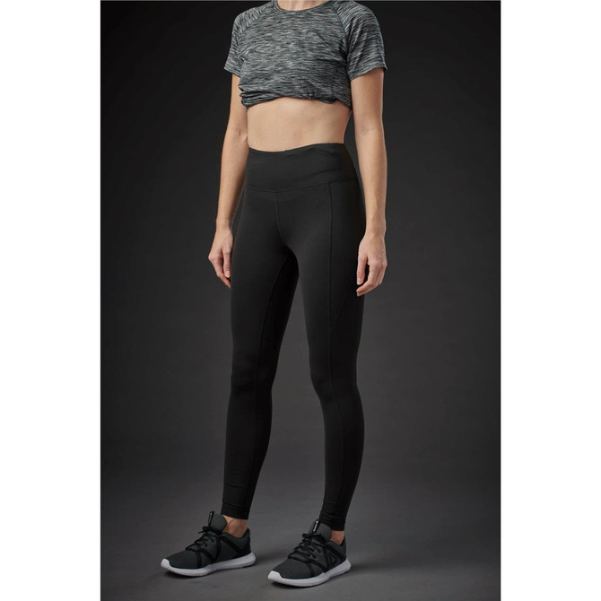 A pair of sleek black women's leggings with a high waistband, shown on a model in a casual setting.