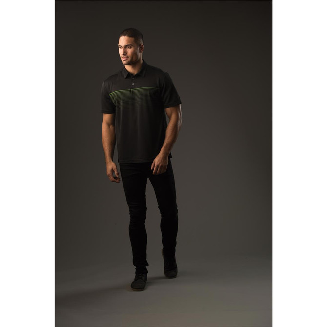 A black polo shirt with green stripe detailing, featuring a collar and short sleeves, worn by a model standing.