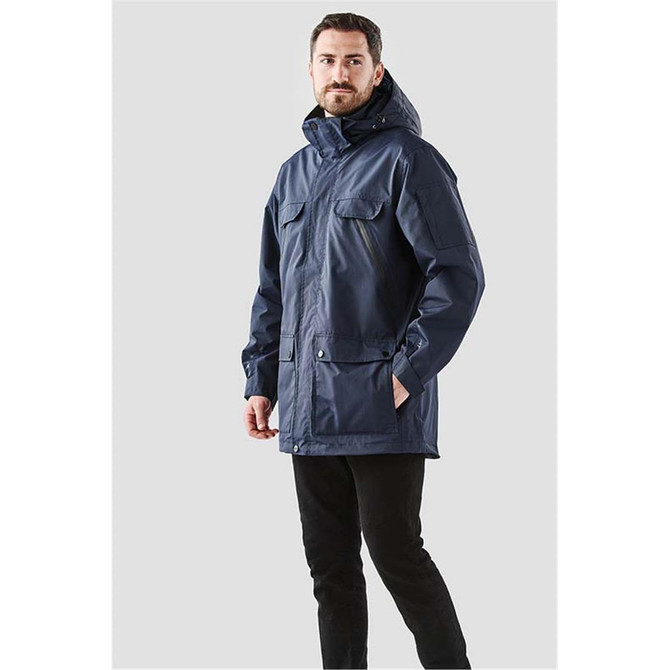 A navy blue men's jacket with multiple pockets and a hood, featuring a logo on the sleeve.