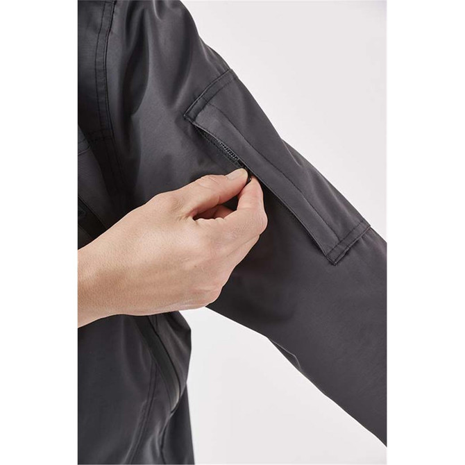 A black women's jacket featuring a sleeve pocket. The fabric appears lightweight and versatile. Includes branding.
