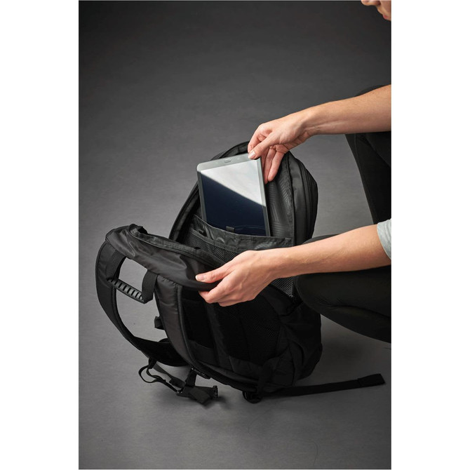 A black laptop bag with a person placing a laptop into a padded compartment. The bag features a logo.